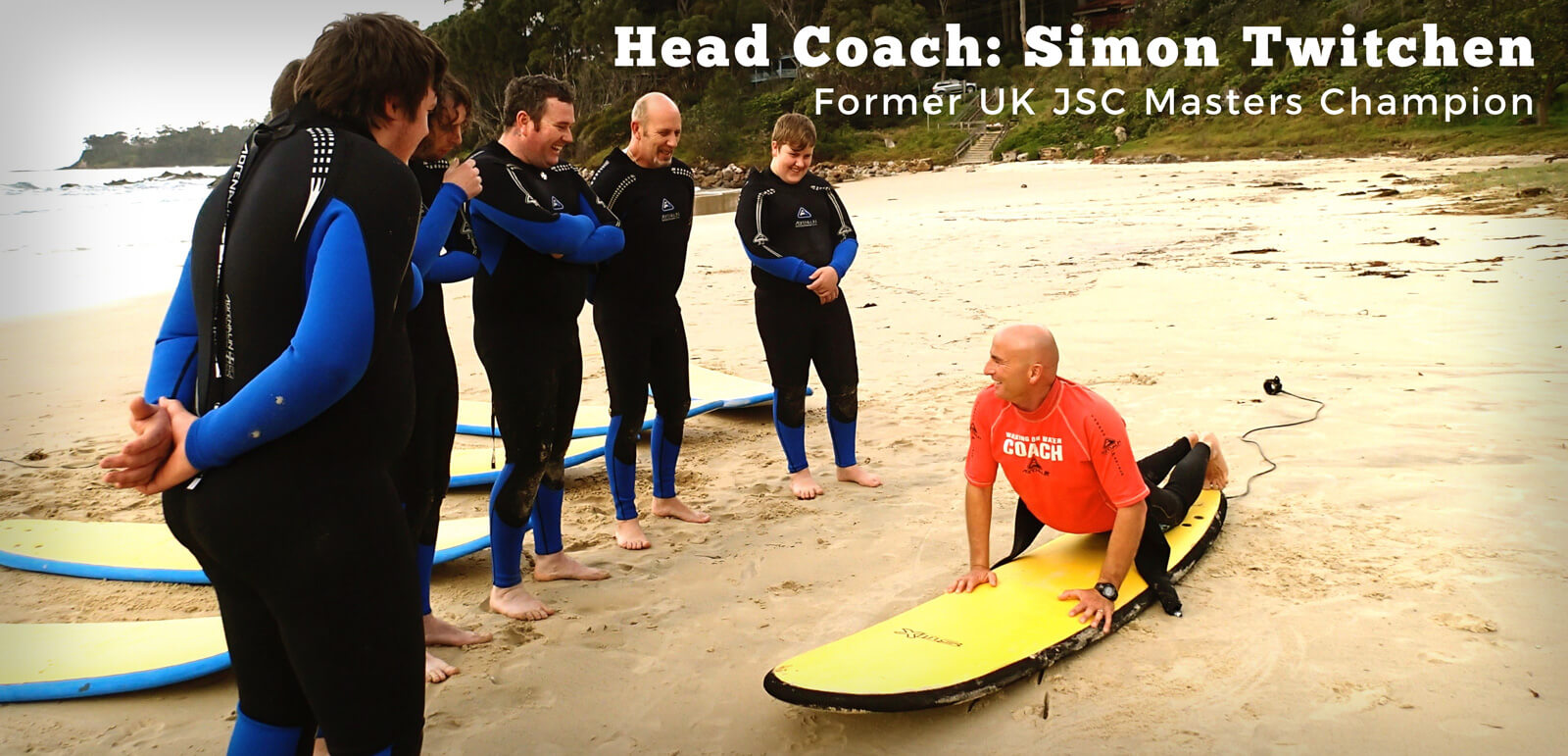 WOW & Ulladulla Surf Schools Head Coach demonstrating surf board position to learning group looking on
