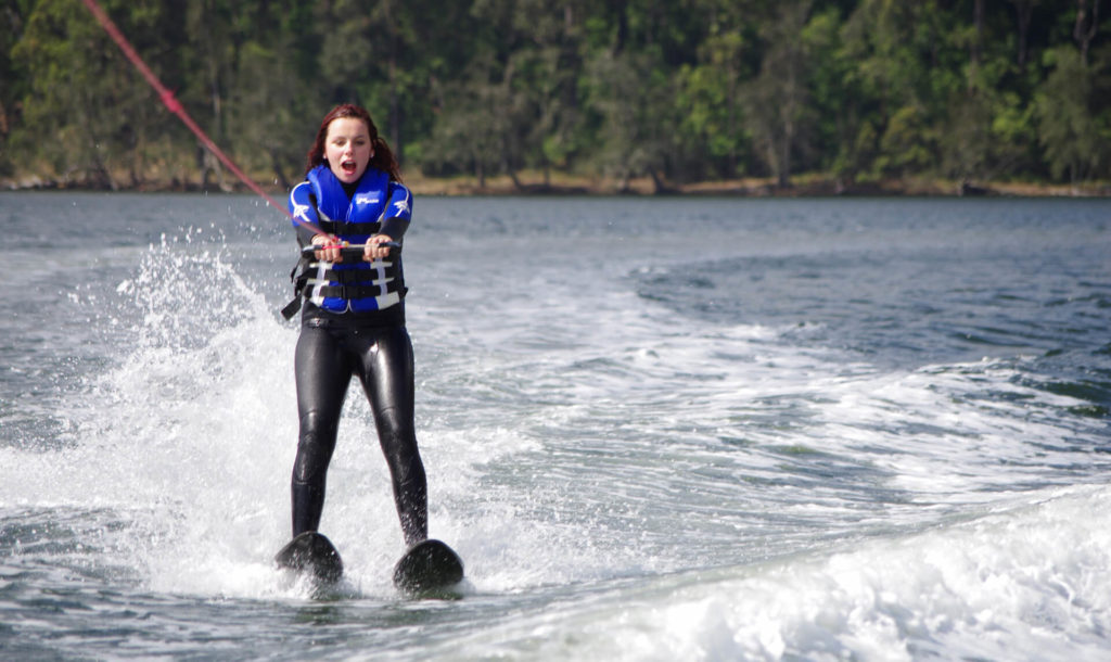 Excited girl water skiing