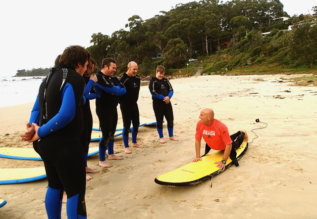 Beginner surf lesson in progress at Ulladulla beach with WOW Watersports instructor