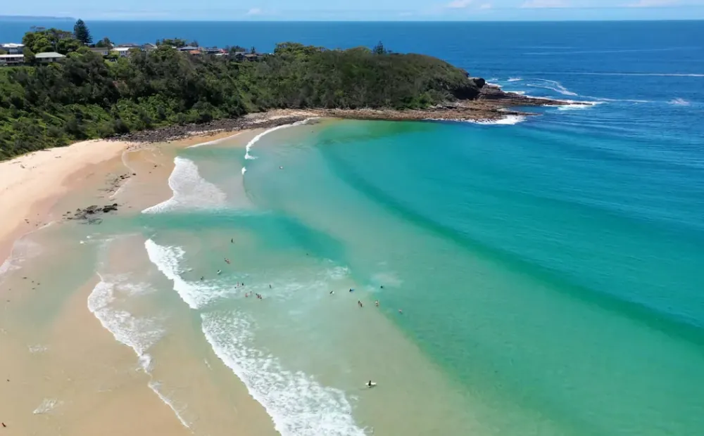 Ulladulla Beach Australia aerial photograph featuring ocean surf breaks and protected inlet - ideal surfing lessons location on NSW South Coast